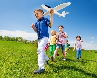 Kids running in field Lifestyle. Tarpon Bay New Homes in Haines City, FL